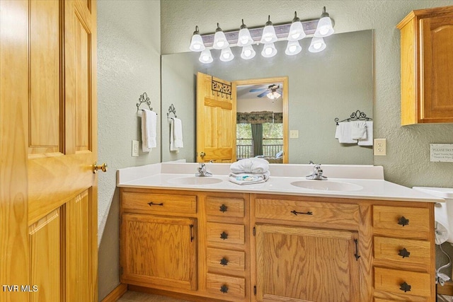 2213 Woodcock Trl, Sevierville, TN 37876 - bathroom with a textured wall, a ceiling fan, and double vanity