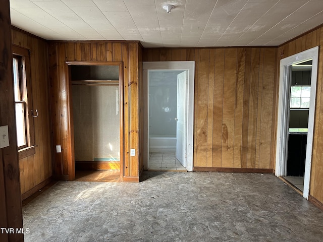 276 Spurgeon Ln, Bristol, VA 24201 - unfurnished bedroom featuring multiple windows, wood walls, baseboards, a closet, and ensuite bathroom