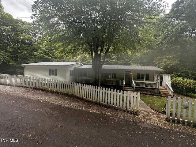 11510 Dogwood Ln, Pound, VA 24279 - manufactured / mobile home featuring a porch, metal roof, and a fenced front yard