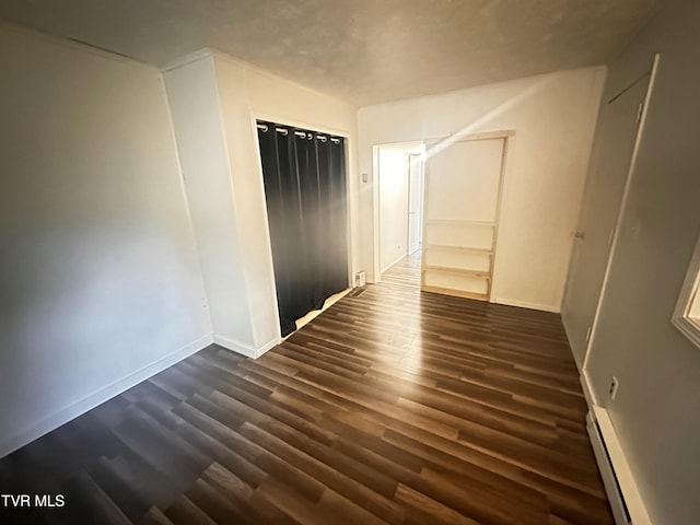 11510 Dogwood Ln, Pound, VA 24279 - bonus room with baseboard heating, dark wood finished floors, and baseboards