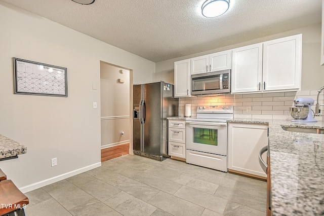 118 Greenmeadow Ln, Jonesborough, TN 37659 - kitchen featuring stainless steel microwave, white electric range, black fridge, white cabinets, and a textured ceiling