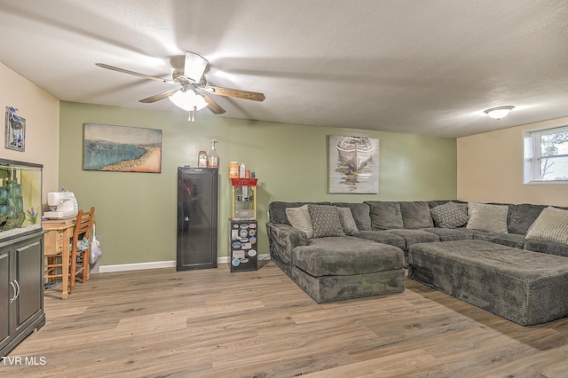 118 Greenmeadow Ln, Jonesborough, TN 37659 - living room featuring a ceiling fan, light wood-style flooring, baseboards, and a textured ceiling