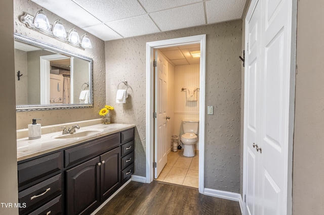 3215 N River Rd Unit 106, Pigeon Forge, TN 37863 - bathroom featuring vanity, toilet, wood finished floors, and a paneled ceiling