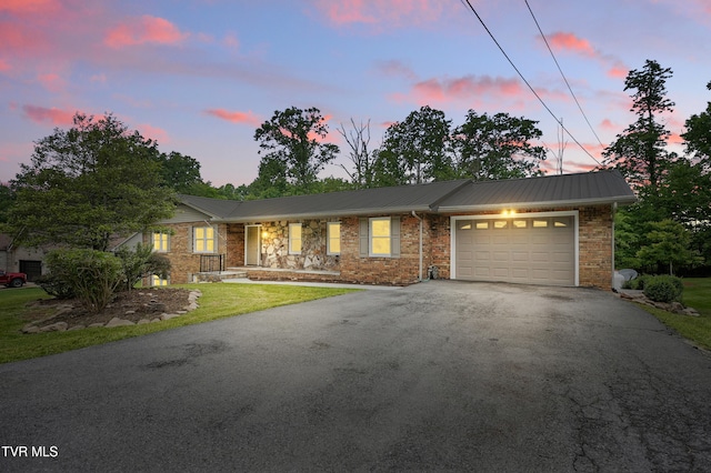 5530 Paramont Rd, Wise, VA 24293 - ranch-style home featuring driveway, an attached garage, metal roof, and brick siding