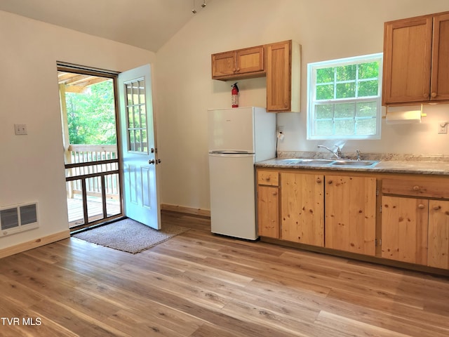 2428 Middle Creek Rd, Afton, TN 37616 - kitchen featuring freestanding refrigerator, a sink, vaulted ceiling, light wood finished floors, and light countertops