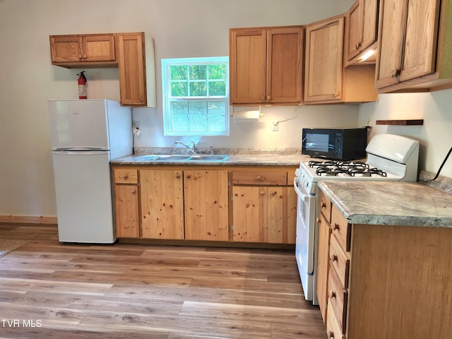 2428 Middle Creek Rd, Afton, TN 37616 - kitchen with white appliances, a sink, light wood-type flooring, and light countertops