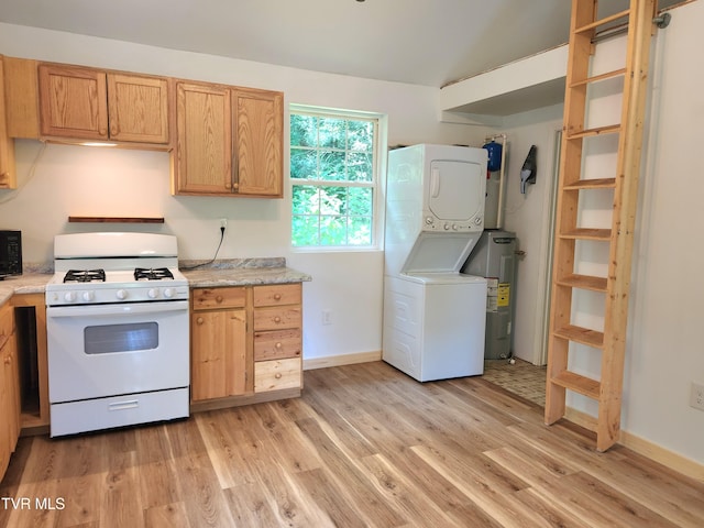 2428 Middle Creek Rd, Afton, TN 37616 - kitchen featuring gas range gas stove, estacked washer and dryer, light wood-type flooring, and light countertops