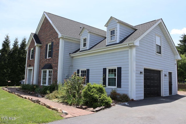 21164 Vances Mill Rd, Abingdon, VA 24211 - view of side of home featuring asphalt driveway, an attached garage, and a shingled roof