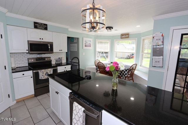 21164 Vances Mill Rd, Abingdon, VA 24211 - kitchen featuring appliances with stainless steel finishes, a sink, dark countertops, a chandelier, and white cabinetry