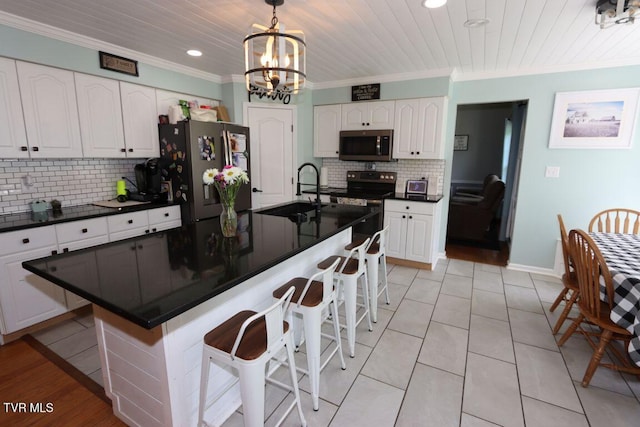 21164 Vances Mill Rd, Abingdon, VA 24211 - kitchen with stainless steel appliances, a sink, dark countertops, crown molding, and white cabinets