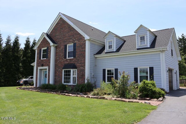 21164 Vances Mill Rd, Abingdon, VA 24211 - view of front facade with a front yard, an attached garage, brick siding, and driveway