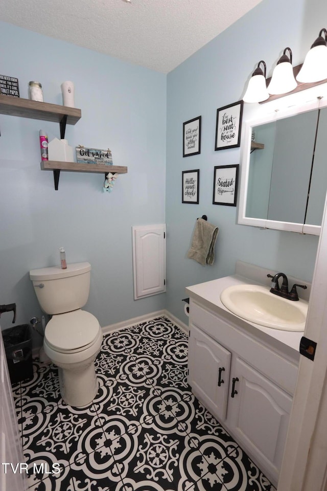 21164 Vances Mill Rd, Abingdon, VA 24211 - bathroom with toilet, vanity, baseboards, tile patterned flooring, and a textured ceiling