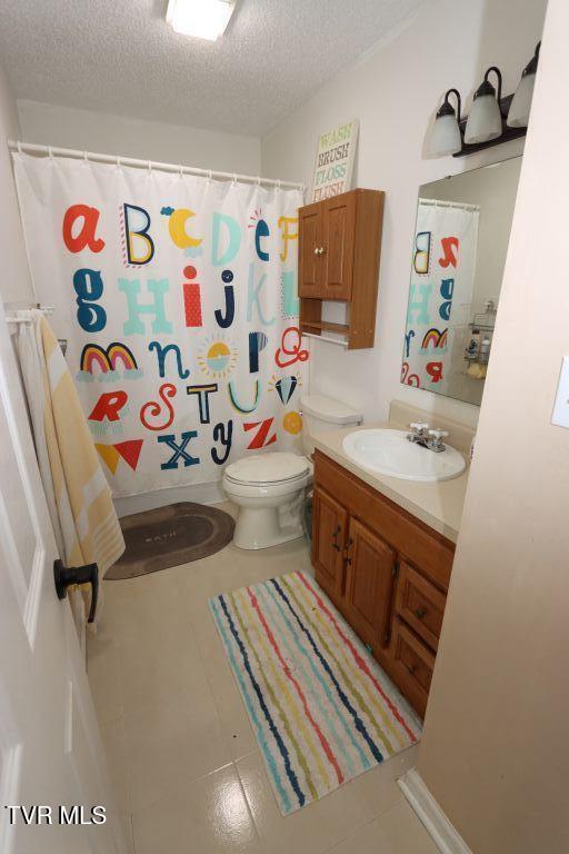 21164 Vances Mill Rd, Abingdon, VA 24211 - full bath featuring toilet, a textured ceiling, vanity, tile patterned floors, and a shower with shower curtain