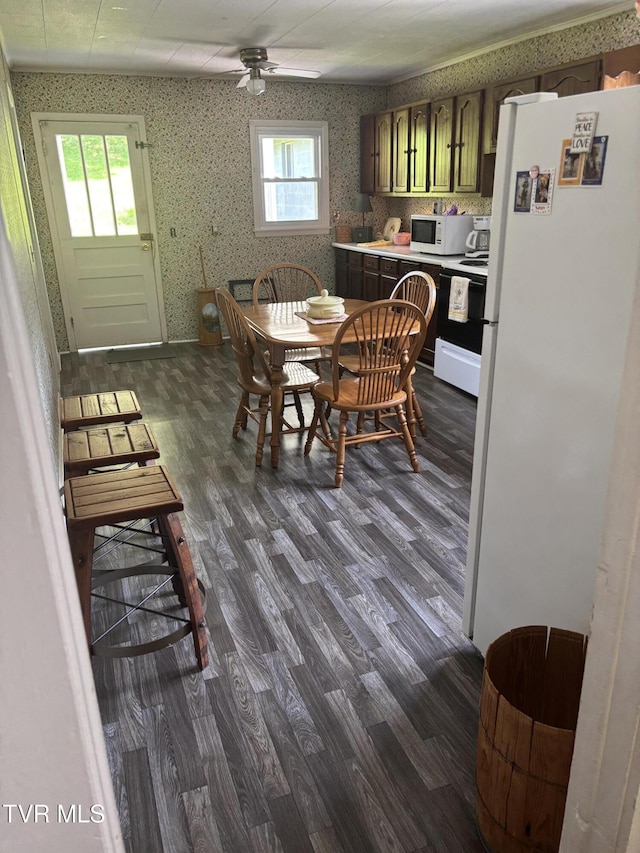 181 Powerhouse Holw, Clintwood, VA 24228 - dining space with wallpapered walls, dark wood-type flooring, and a ceiling fan