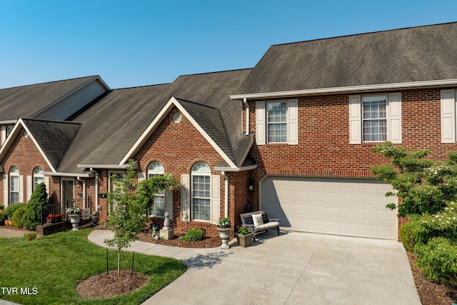 404 E Mountain View Rd Unit 204, Johnson City, TN 37601 - view of front of home featuring driveway, brick siding, a garage, and roof with shingles
