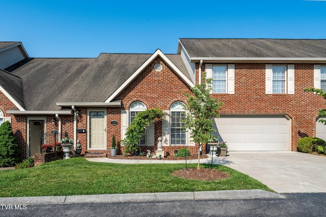 404 E Mountain View Rd Unit 204, Johnson City, TN 37601 - view of front of property featuring brick siding, driveway, roof with shingles, and an attached garage