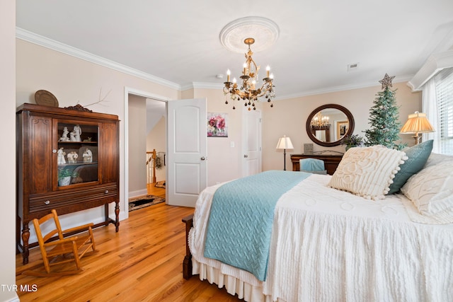 404 E Mountain View Rd Unit 204, Johnson City, TN 37601 - bedroom featuring a chandelier, crown molding, light wood-style flooring, and baseboards