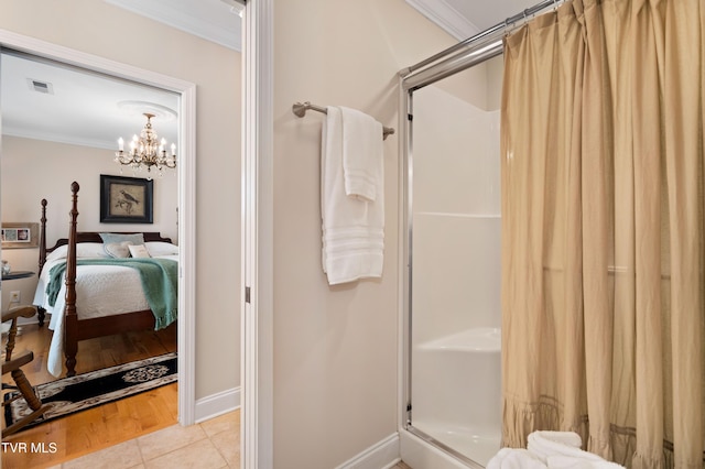 404 E Mountain View Rd Unit 204, Johnson City, TN 37601 - full bath featuring crown molding, a stall shower, a chandelier, baseboards, and connected bathroom