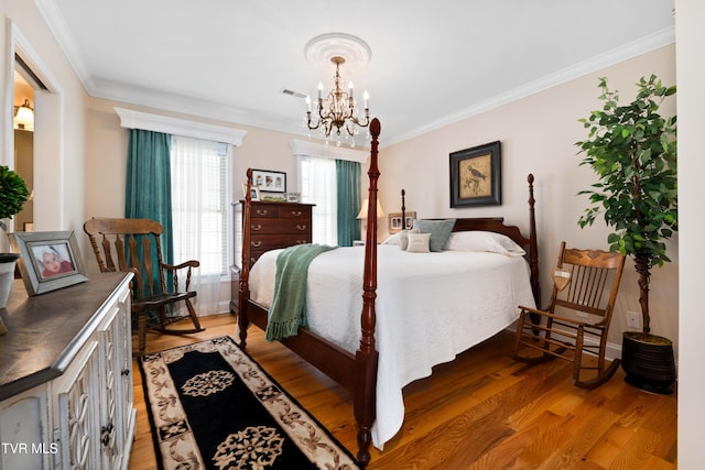 404 E Mountain View Rd Unit 204, Johnson City, TN 37601 - bedroom featuring ornamental molding, light wood-style floors, and a chandelier
