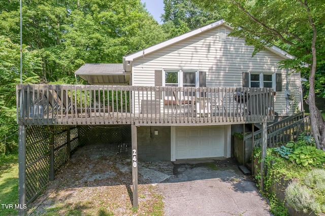 240 Watson Rd, Bristol, TN 37620 - back of property with asphalt driveway, an attached garage, and a deck