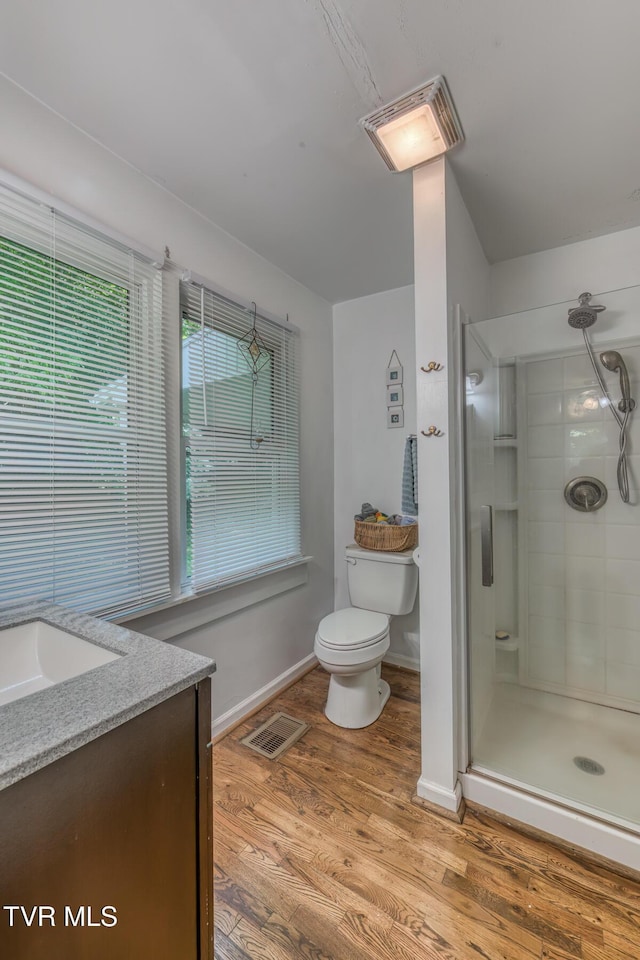 240 Watson Rd, Bristol, TN 37620 - bathroom with toilet, a shower stall, vanity, wood finished floors, and baseboards