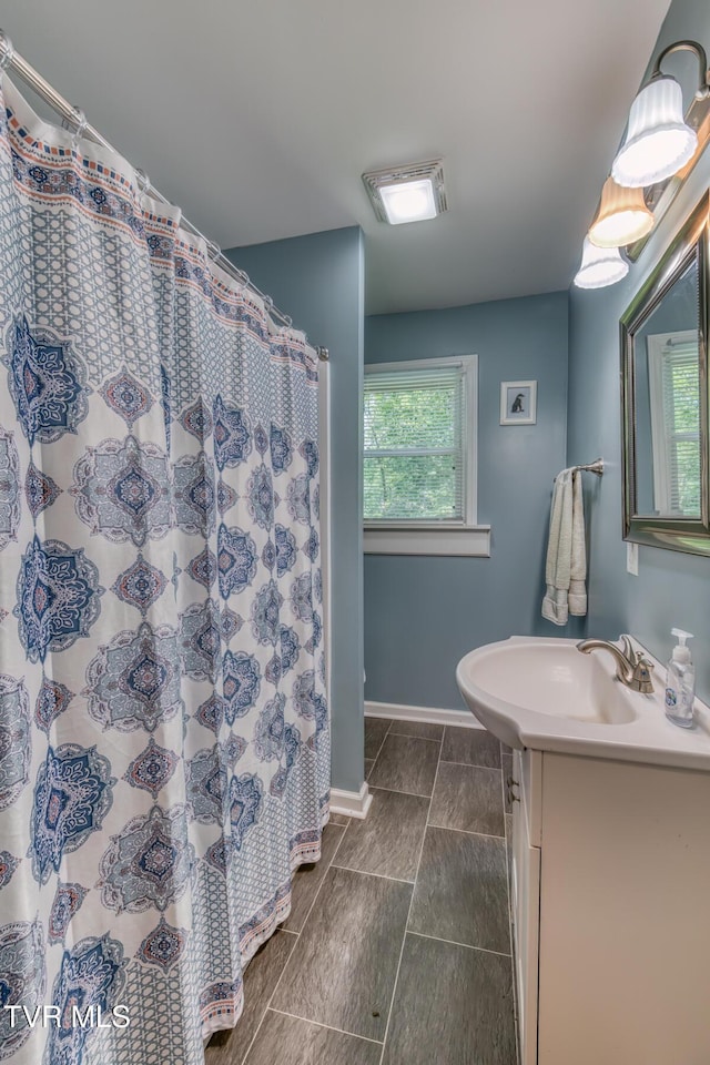 240 Watson Rd, Bristol, TN 37620 - full bath featuring vanity, baseboards, and a shower with curtain