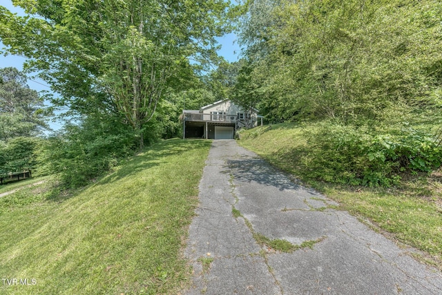 240 Watson Rd, Bristol, TN 37620 - view of front of property featuring driveway, a garage, a front lawn, and a wooden deck