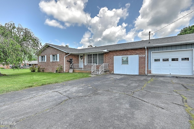 509 9th St, Erwin, TN 37650 - ranch-style home with an attached garage, brick siding, driveway, and a front lawn