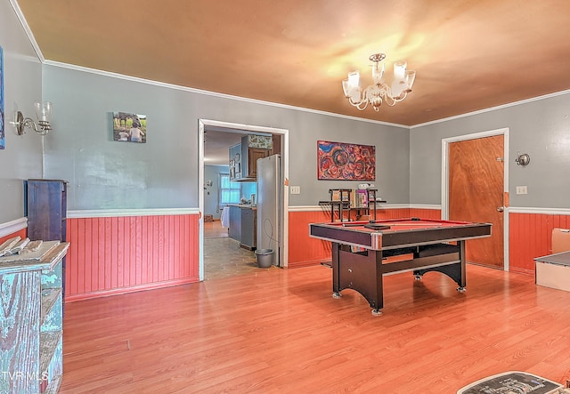 509 9th St, Erwin, TN 37650 - playroom featuring a wainscoted wall, light wood-style flooring, pool table, a chandelier, and ornamental molding