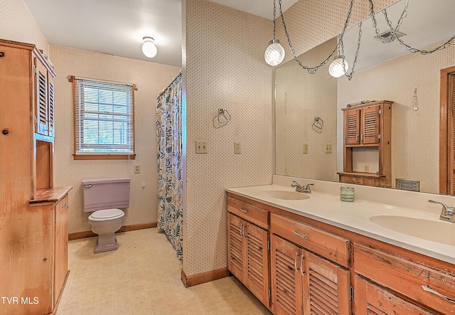 509 9th St, Erwin, TN 37650 - bathroom with toilet, double vanity, curtained shower, and baseboards