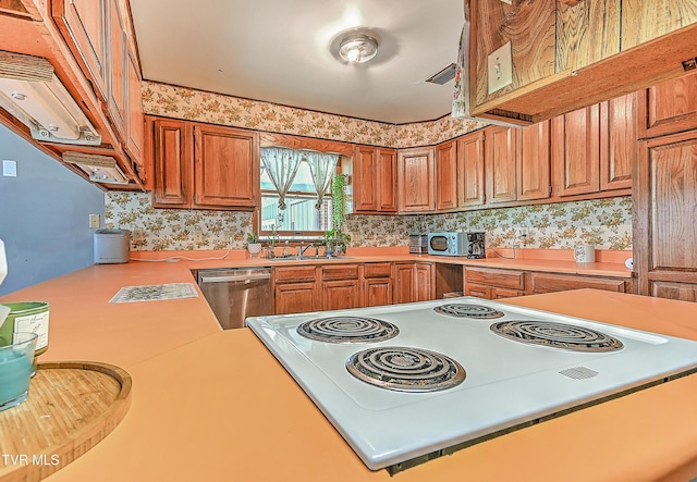 509 9th St, Erwin, TN 37650 - kitchen featuring range, stainless steel dishwasher, brown cabinetry, light countertops, and backsplash