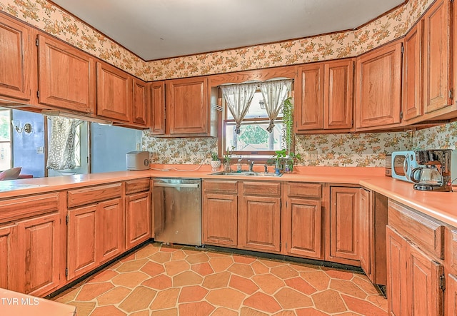 509 9th St, Erwin, TN 37650 - kitchen featuring stainless steel dishwasher, light countertops, a sink, brown cabinetry, and light tile patterned floors