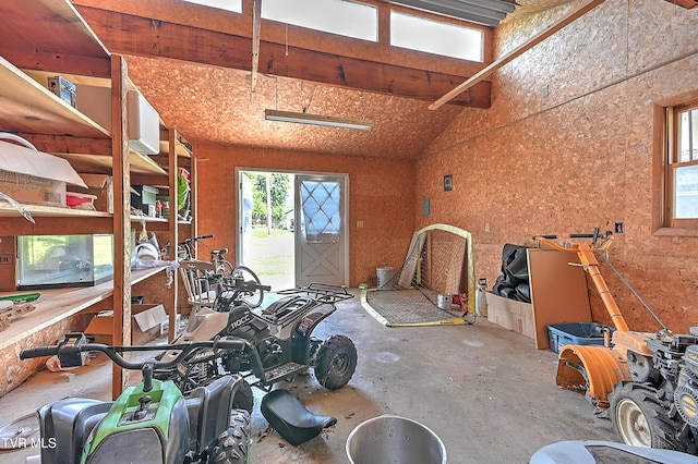 509 9th St, Erwin, TN 37650 - misc room with plenty of natural light, concrete floors, vaulted ceiling, and a garage