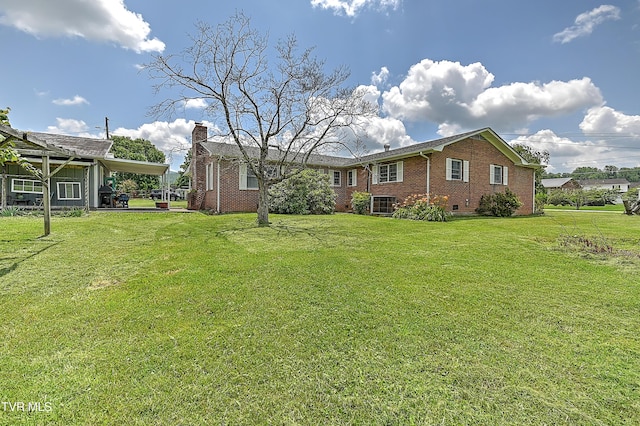 509 9th St, Erwin, TN 37650 - view of front of house featuring brick siding, a carport, a front lawn, and a chimney