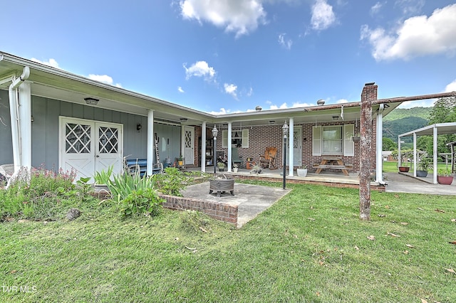 509 9th St, Erwin, TN 37650 - back of property with a lawn, a chimney, and a patio