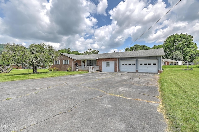 509 9th St, Erwin, TN 37650 - single story home featuring driveway, an attached garage, brick siding, a front lawn, and a shingled roof