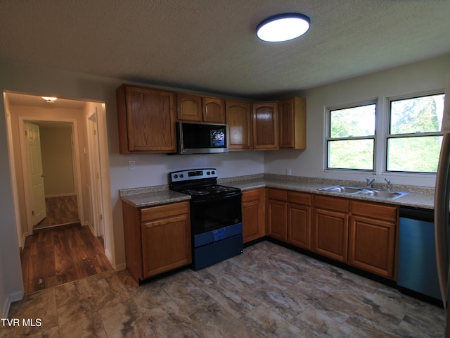 321 W Chilhowie Ave, Johnson City, TN 37604 - kitchen featuring electric range, stainless steel microwave, a sink, dishwasher, and brown cabinetry