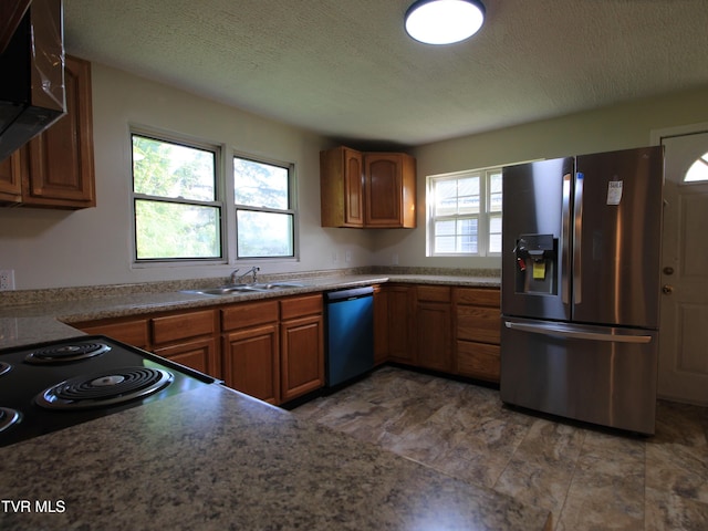 321 W Chilhowie Ave, Johnson City, TN 37604 - kitchen with stainless steel refrigerator with ice dispenser, dishwashing machine, brown cabinetry, a textured ceiling, and a sink