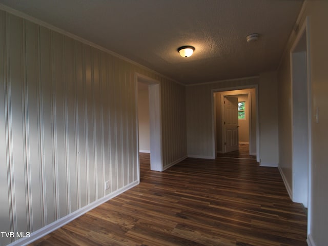 321 W Chilhowie Ave, Johnson City, TN 37604 - spare room featuring baseboards, dark wood-style floors, a smoke detector, a textured ceiling, and crown molding