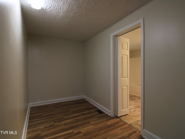 321 W Chilhowie Ave, Johnson City, TN 37604 - unfurnished room featuring dark wood-style floors, a textured ceiling, and baseboards