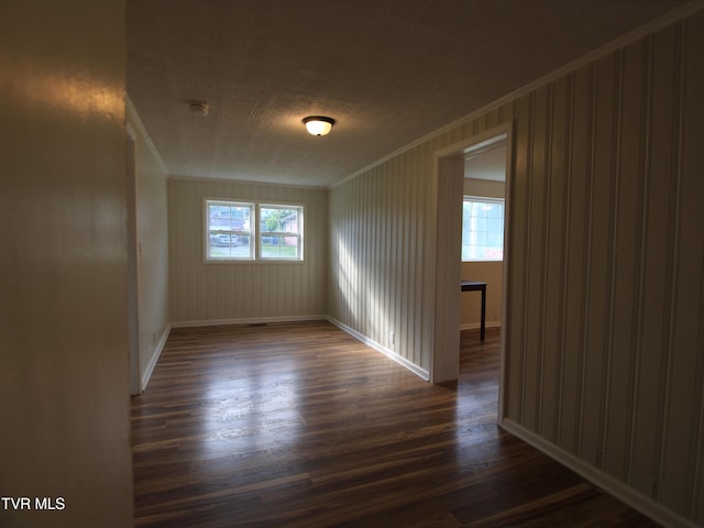 321 W Chilhowie Ave, Johnson City, TN 37604 - spare room featuring crown molding, dark wood-style flooring, baseboards, a textured ceiling, and a smoke detector