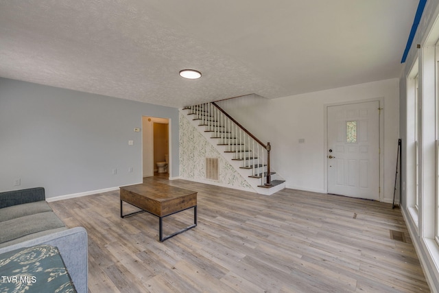 23270 Denton Valley Rd, Abingdon, VA 24211 - unfurnished living room featuring stairway, wood finished floors, baseboards, and a textured ceiling