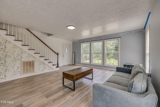 23270 Denton Valley Rd, Abingdon, VA 24211 - living area featuring a textured ceiling, stairway, wood finished floors, and baseboards