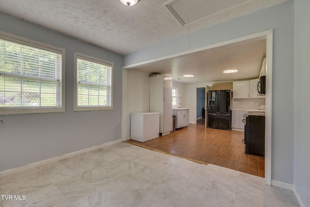 23270 Denton Valley Rd, Abingdon, VA 24211 - kitchen featuring black appliances, light countertops, baseboards, and white cabinets