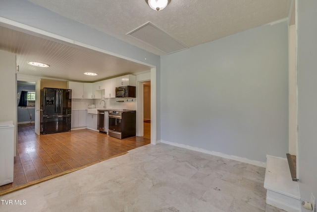 23270 Denton Valley Rd, Abingdon, VA 24211 - kitchen featuring black appliances, light countertops, a sink, white cabinetry, and baseboards