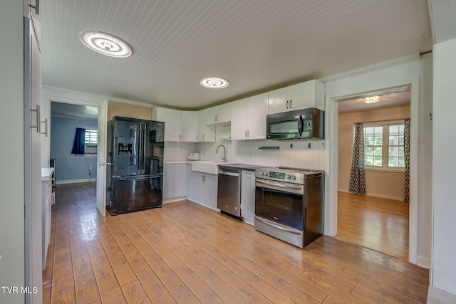 23270 Denton Valley Rd, Abingdon, VA 24211 - kitchen with black appliances, a sink, crown molding, baseboards, and light wood finished floors