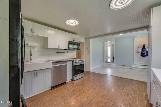 23270 Denton Valley Rd, Abingdon, VA 24211 - kitchen with black appliances, a sink, light wood finished floors, baseboards, and light countertops