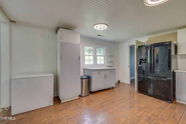 23270 Denton Valley Rd, Abingdon, VA 24211 - kitchen featuring black fridge, white fridge, light countertops, light wood-style flooring, and wooden ceiling