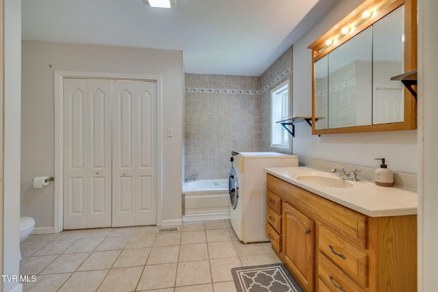 23270 Denton Valley Rd, Abingdon, VA 24211 - bathroom with washer / clothes dryer, vanity, tile patterned floors, a tub, and toilet