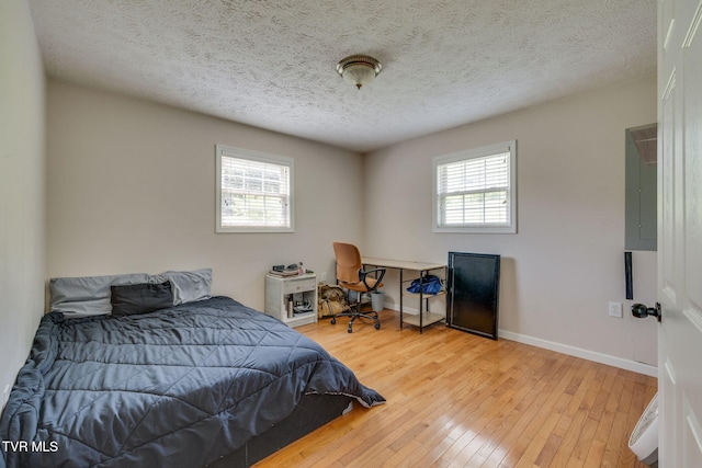 23270 Denton Valley Rd, Abingdon, VA 24211 - bedroom with hardwood / wood-style floors, baseboards, a textured ceiling, and electric panel